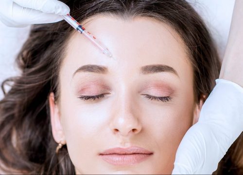 Woman receiving cosmetic injectables