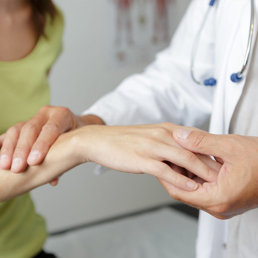 Doctor addressing a patient's wrist pain