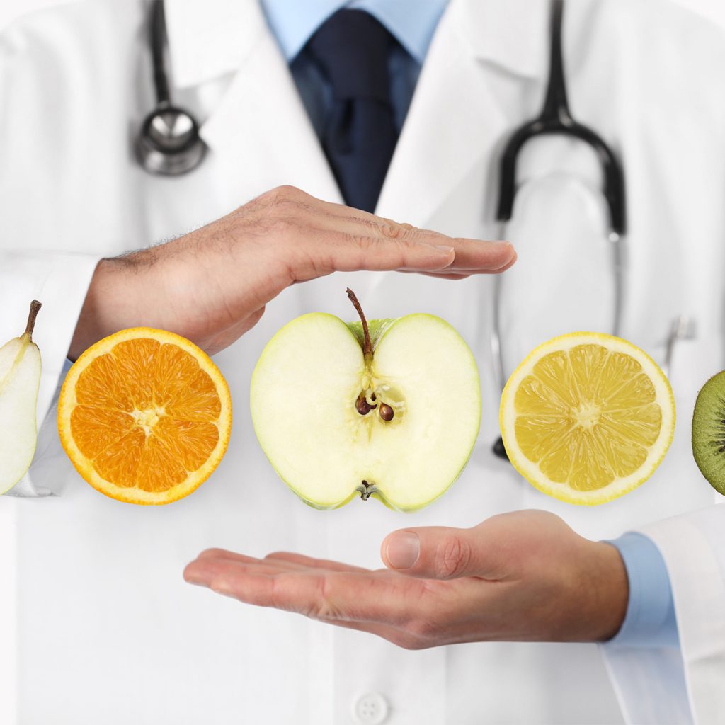 Fruit in front of a doctor's chest