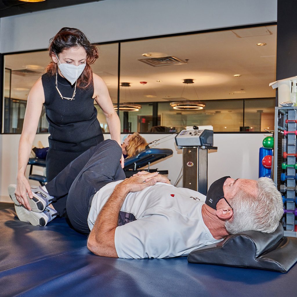 Older man receiving physical therapy treatments