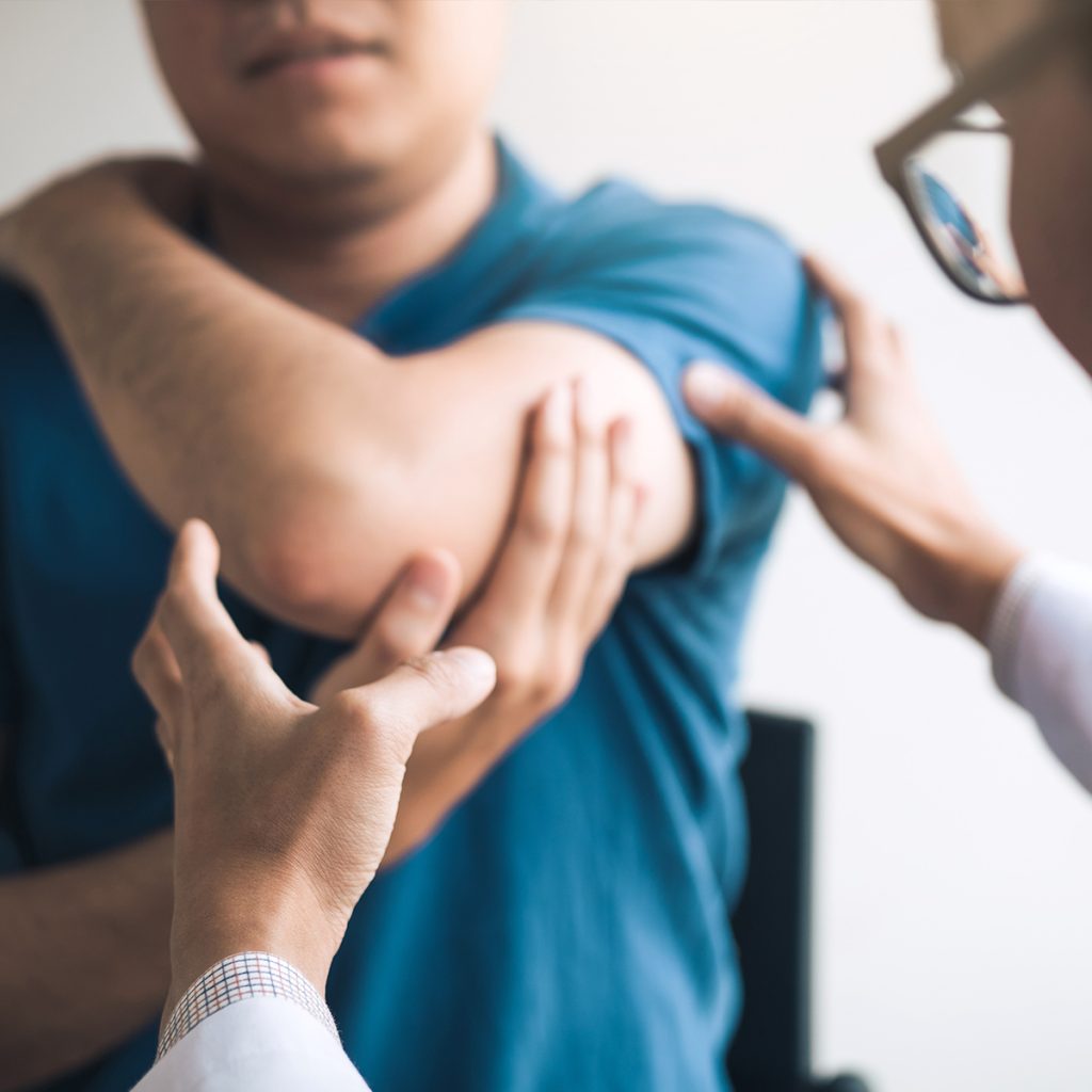 Doctor addressing a patient's shoulder pain