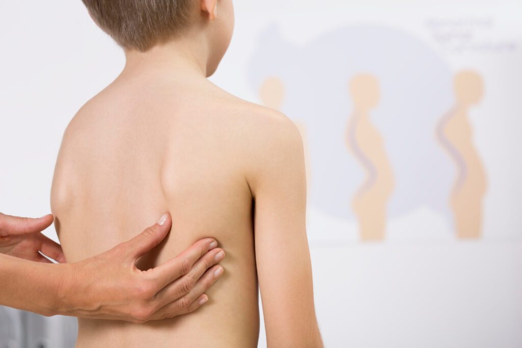 Cropped picture of a doctor checking a boy's back