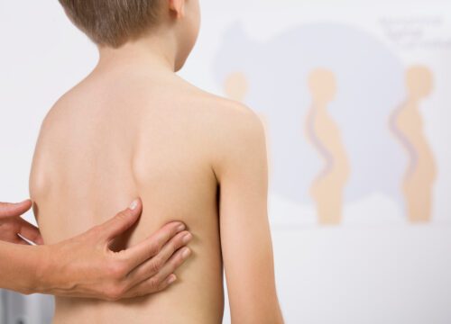 Cropped picture of a doctor checking a boy's back