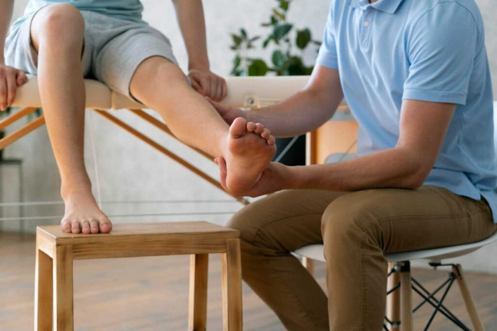 Physiotherapist massaging knee of patient for recovery