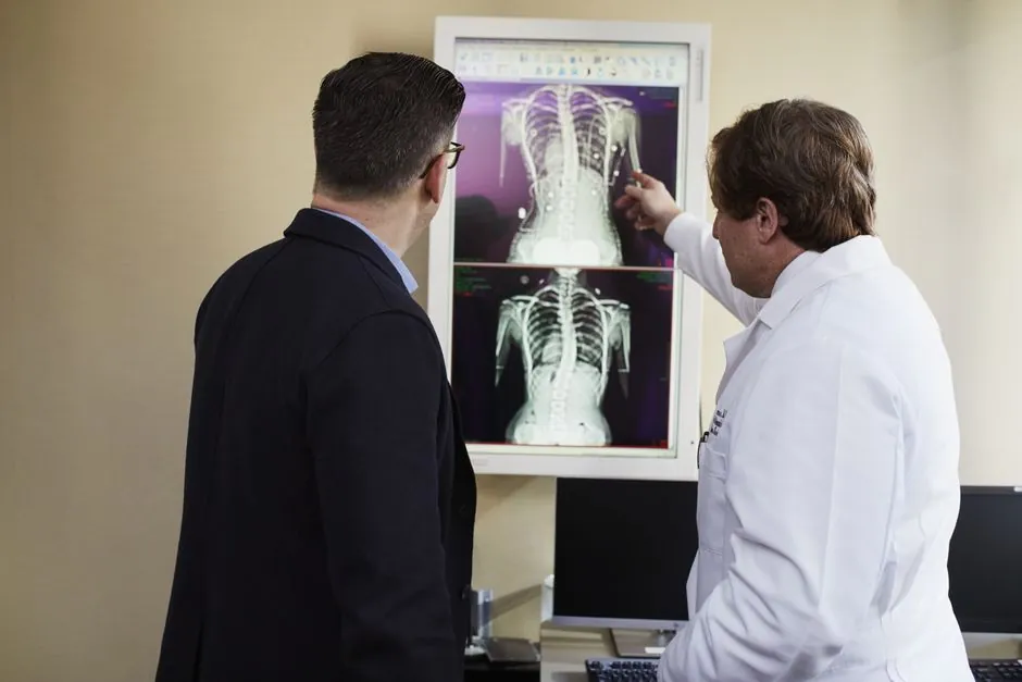 Doctor explaining spine X-rays to a patient