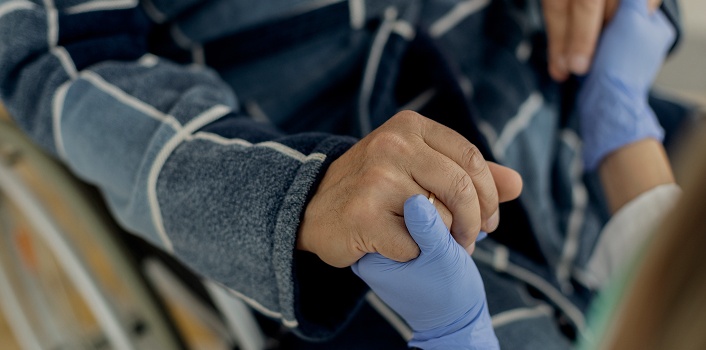 closeup-senior-man-home-caregiver-holding-hands 1 (1)