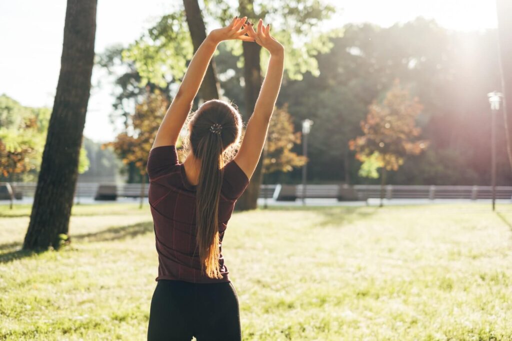 rear-view-of-sport-woman-stretching-in-the-park-2026-03-17-17-49-32-utc